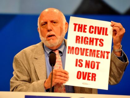 Mark Levy holding poster stating: The Civil Rights Movement is Not Over